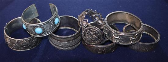 Seven assorted white metal bangles.